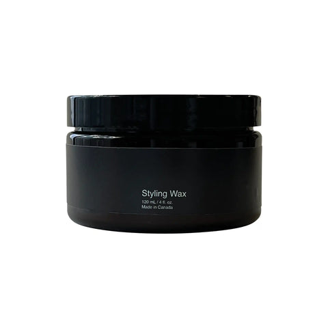 Black jar of styling wax on a white background