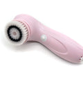 Pink skin care brush with bristle head on a white background