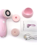 Pink facial cleansing brush set with attachments and USB cable on a white background