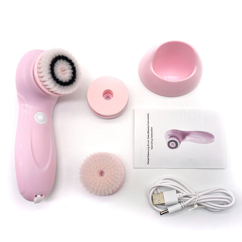 Pink facial cleansing brush set with attachments and USB cable on a white background