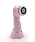 Pink facial cleansing brush with a white bristle head on a white background