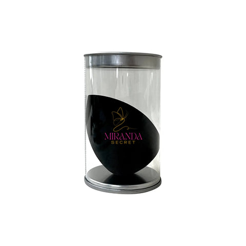Black product in a clear cylindrical container with 'Miranda Secret' branding on a white background