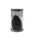 Black makeup sponge in a clear cylindrical container on a white background