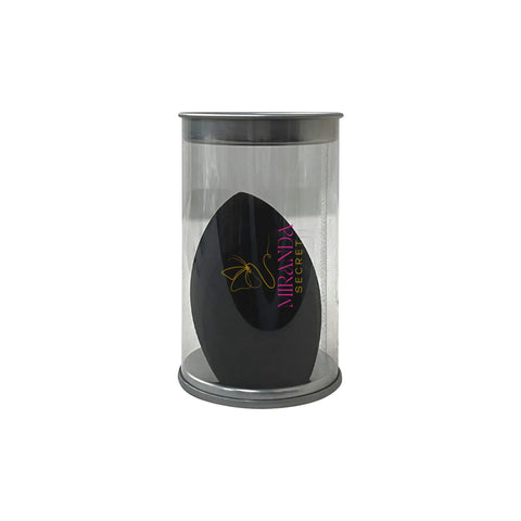 Black makeup sponge in a clear cylindrical container on a white background