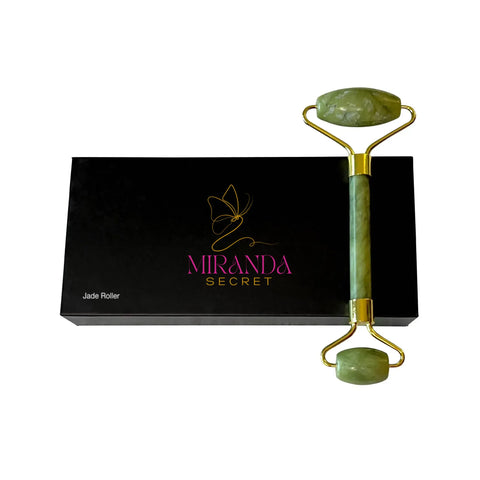 Green jade roller with gold accents on a black box labeled 'Miranda Secret' against a white background.