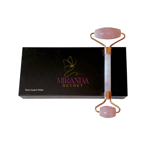 Rose Quartz Roller with gold accents on a black box labeled 'Miranda Secret' against a white background