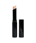 Black cosmetic stick with beige applicator on a white background