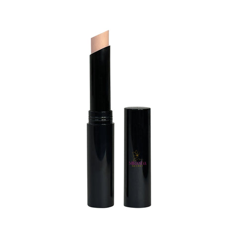 Black cosmetic stick with beige applicator on a white background