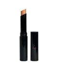 Black cosmetic stick with a beige applicator on a white background