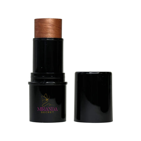 Makeup stick with bronze top and black casing on a white background, featuring Miranda Secret logo.