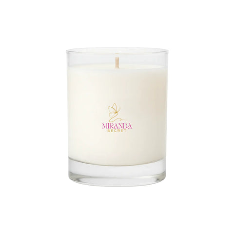 White candle in a glass jar with 'Miranda' logo on a white background