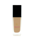 Foundation bottle with black cap and beige body on a white background