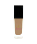 Foundation bottle with black cap and beige body on a white background
