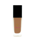 Foundation bottle with black cap and visible brand logo on a white background