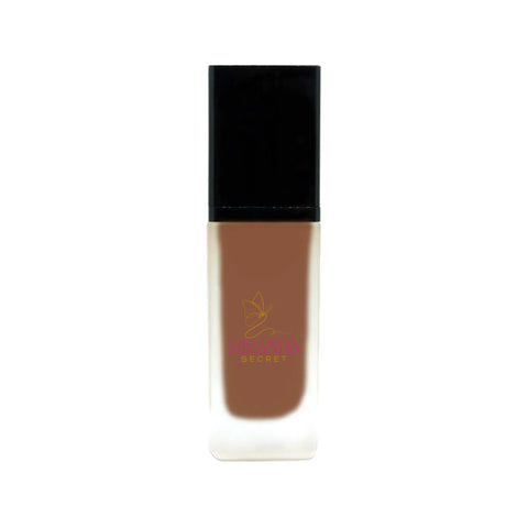 Cosmetic bottle with brown shade and black cap on a white background