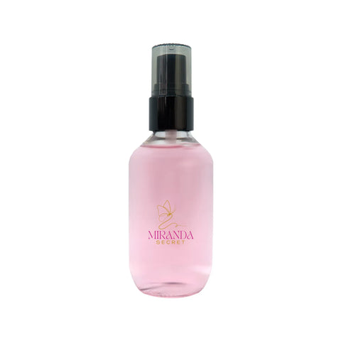 Pink spray bottle with black nozzle on a white background, featuring the Miranda Secret logo.