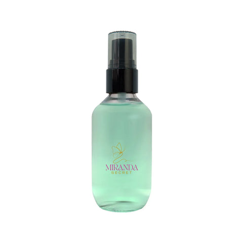 Green spray bottle with black nozzle on a white background, featuring the Miranda Secret brand.