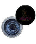 Open jar of blue powder with black lid featuring Miranda Secret logo on a white background