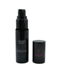 Black cosmetic bottle with pump and cap on a white background
