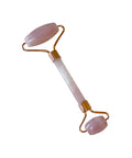 Rose quartz facial roller on a white background