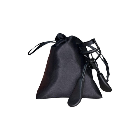 Black eyelash curler with a matching black pouch on a white background