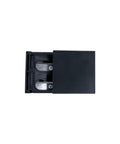 Black cassette tape with open lid on a white background