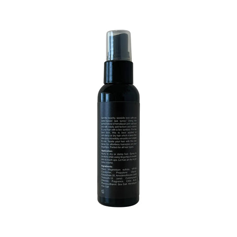 Black spray bottle with silver nozzle on a white background