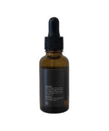 Amber glass dropper bottle with black cap on a white background
