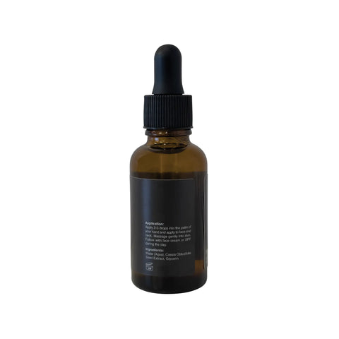 Amber glass dropper bottle with black cap on a white background