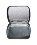 Compact mirror with speckled surface on a white background