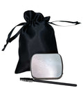 Silver makeup compact with black brush and black drawstring bag on a white background