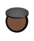 Compact brown powder in a black case on a white background