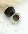Eyebrow gel with black cap on a white background