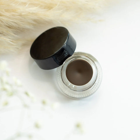 Eyebrow gel with black cap on a white background
