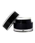 Black cosmetic jar with a white lid on a white background