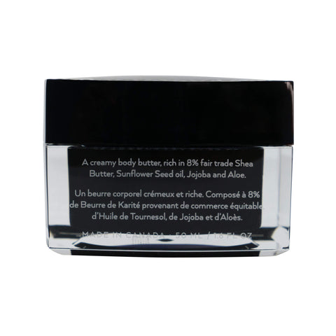 Creamy body butter jar with black lid and clear container on a white background