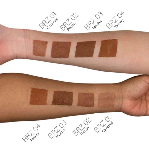 Swatches of brown makeup shades on a person's arm with color names below.