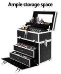 Black makeup storage case with multiple drawers and cosmetic items on a white background