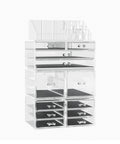 Clear acrylic jewelry display case with multiple drawers on a white background