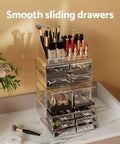 Makeup organizer with various cosmetic items on a marble surface with a beige wall background.