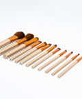 Set of makeup brushes with wooden handles on a white background