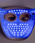 LED face mask with blue light on a gray background