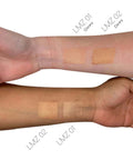 Swatches of makeup on a person's arm with labels indicating 'Glowy' and 'Dewy' finishes.