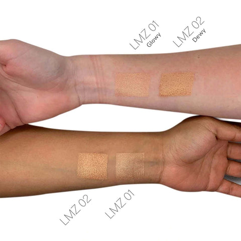 Swatches of makeup on a person's arm with labels indicating 'Glowy' and 'Dewy' finishes.