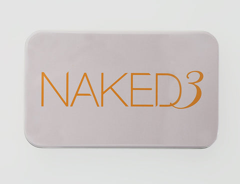 Makeup palette with 'NAKED3' text on a light gray background