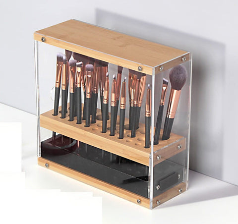 Makeup brush set in a wooden and acrylic holder on a white background