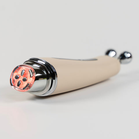 Beige handheld device with a metallic finish on a light gray background