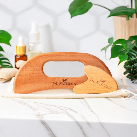 Wooden roller with J&L Naturals branding on a white surface with plants in the background